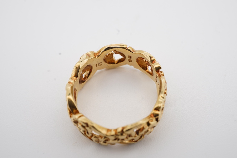 An early 1970's 18ct gold band, of pierced foliate design, maker I.G., London, 1971, size K, 5 grams.